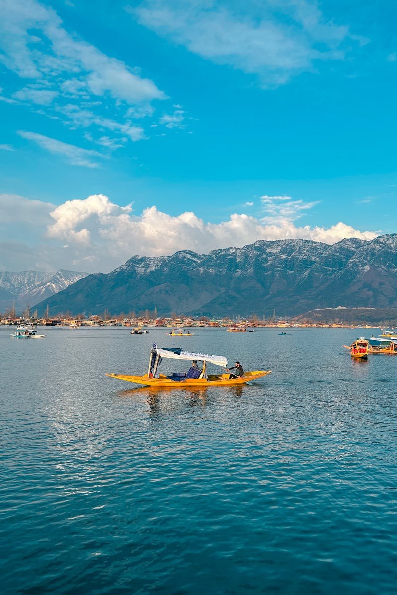 Beautiful Shikara boats on Dal Lake with a backdrop of the majestic Himalayas in Srinagar.
