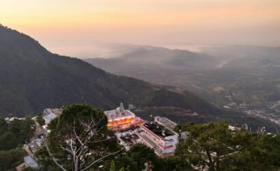 Breathtaking aerial view of Katra with mountains and buildings at twilight, creating a serene and picturesque scene.
